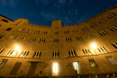 Historic buildings in Piazza del Campo in SIena, Tuscany, Italy, the famous square hosting the Palio, at eveningのeditorial素材