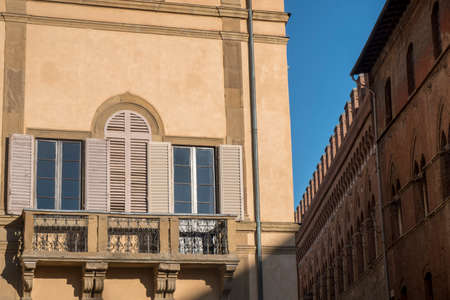 Historic buildings in SIena, Tuscany, Italy, at evening: exterior of a palace near the cathedralのeditorial素材