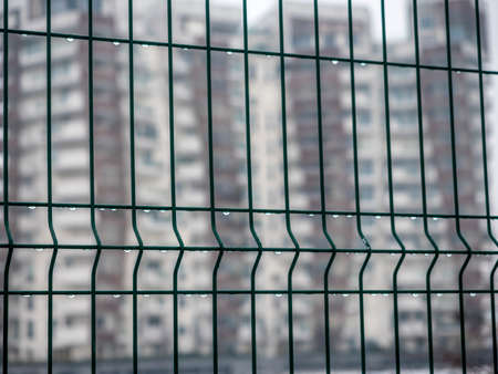 Metallic net with drops of water at winter in Citylife, Milan, Lombardy, Italy