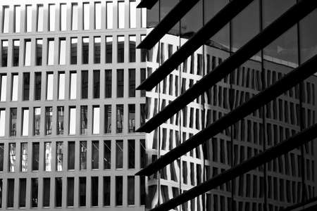 Milan, Lombardy, Italy: modern buildings in Alvar Aalto square. Reflections. Black and white
