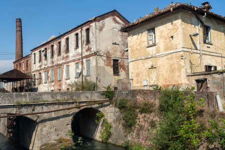 Old buildings along the canal known as Naviglio Pavese, between Pavia and Milan, Lombardy, Italy, at summer, coasted by a bicycle laneの写真素材