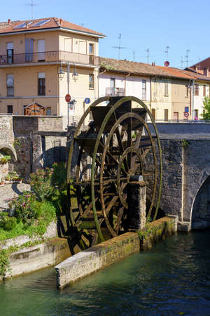 Groppello (Milan, Lombardy, Italy): the big wooden wheel on the Martesana canal known as Rudun and the old bridgeの写真素材