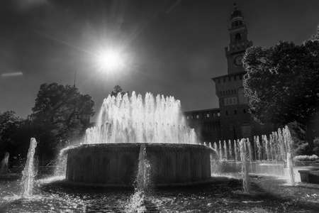 Milan, Lombardy, Italy: historic fountain in the square of the castle known as Castello Sforzesco. Black and whiteのeditorial素材