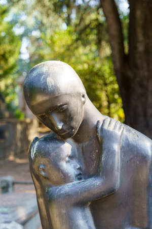 Milan, Lombardy, Italy: historic cemetery known as Cimitero Monumentale: a tomb with statueの写真素材