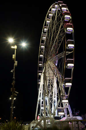 Rimini, Emilia-Romagna, Italy: the big wheel illuminated by night at the harborの写真素材