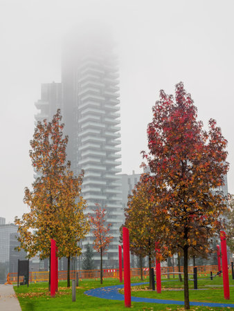 Modern buildings at Porta Nuova, Milan, Lombardy, Italy, and Biblioteca degli Alberi park in a misty November morningの写真素材