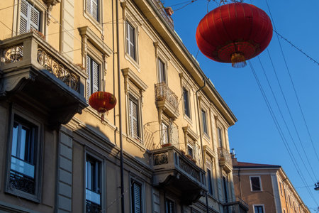 Residential buildings along via Paolo Sarpi in Milan, Lombardy, Italy, with red lanternsの写真素材