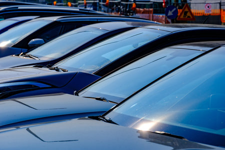 Cars in a raw at a parking along via Faravelli, Milan, Lombardy, Italyの写真素材