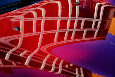 Modern residential building along via Faravelli in Milan, Lombardy, Italy, reflected on a carの写真素材