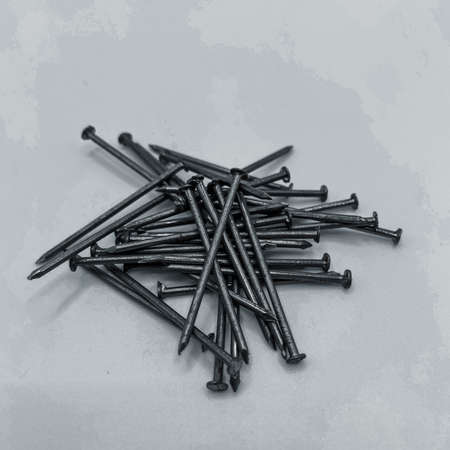 Iron nails lie in the same pileの写真素材