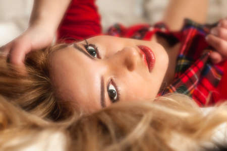 Pretty Blonde Girl in Red Plaid and Red Lipstickの写真素材