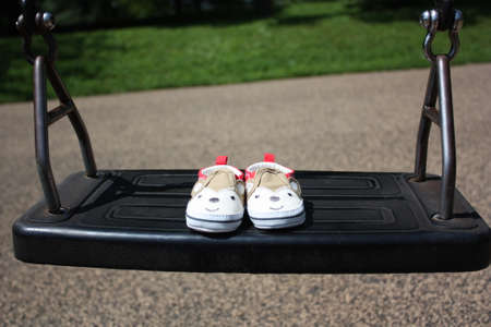 Baby Shoes On A Swingの写真素材