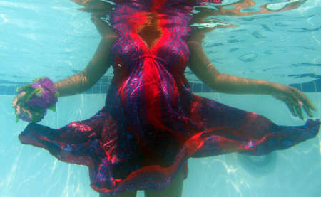 Pregnant woman in waterの写真素材