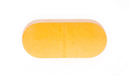 Orange pill isolated on white backgroundの写真素材