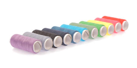 Spools of colours threads isolated on white background