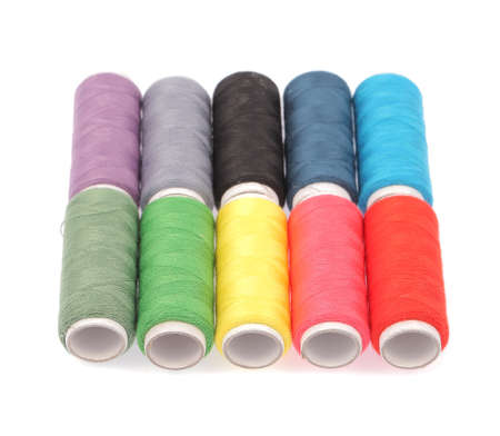 Spools of colours threads isolated on white background