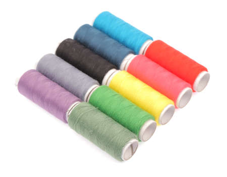 Spools of colours threads isolated on white background