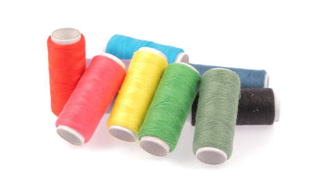 Spools of colours threads isolated on white background