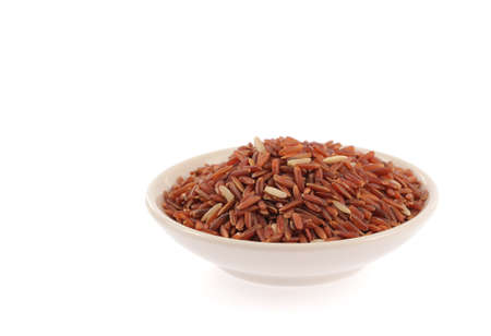 Red rice in bowl isolated on white backgroundの写真素材
