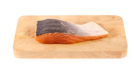 Salmon fillets on wooden cutting board isolated on white backgroundの写真素材