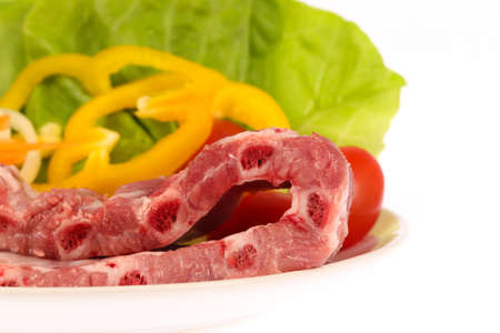 pork ribs on white dish with vegetable isolated on white backgroundの写真素材