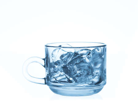 glass cup with ice cubes. Isolated on white backgroundの写真素材