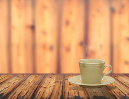 warm cup of coffee on brown wood backgroundの写真素材