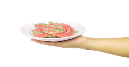 hand holding Jelly sweet, dessert colorful with sugar on plate isolated on white background.の写真素材