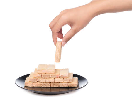 hand holding strawberry waffles on dish isolated on white backgroundの写真素材
