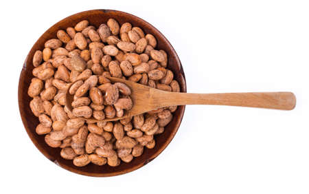 Pinto beans with spoon in dish of beans isolated on white background