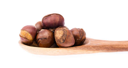 wood ladle of chestnuts isolated on white backgroundの写真素材