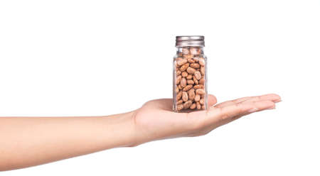 hand holding bottle of Pinto beans isolated on white backgroundの写真素材