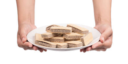hand holding dish of waffles isolated on white backgroundの写真素材