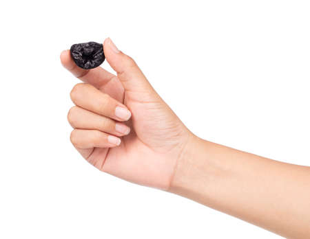 hand holding Dried prune isolated on white backgroundの写真素材