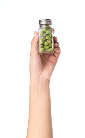 hand holding bottle of Green beans snacks isolated on white backgroundの写真素材