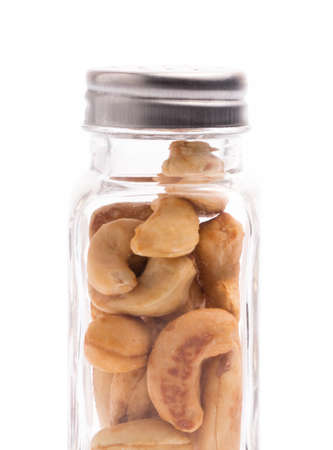 bottle of cashew nuts isolated on white backgroundの写真素材