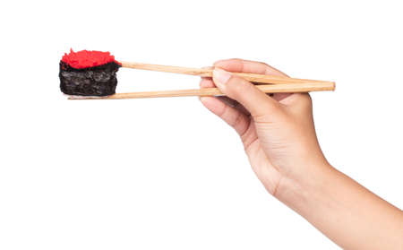 Hand holding sushi by chopsticks isolated on white backgroundの写真素材