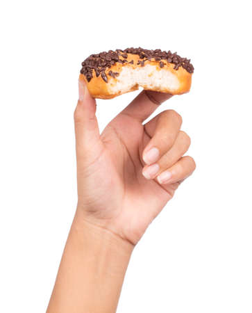 hand holding bite Delicious donut with chocolate isolated on white background.の写真素材