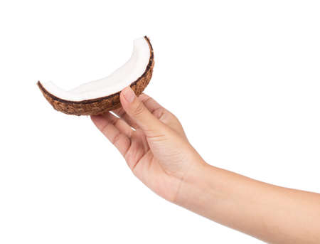 hand holding Coconut Old brown isolated on white backgroundの写真素材