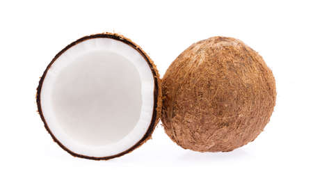 Old brown organic coconut fruit copra broken into pieces and stacked on white background