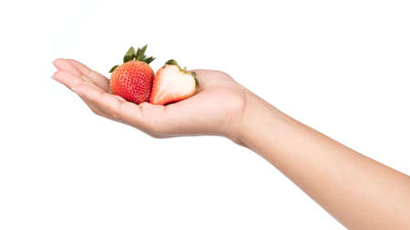 hand holding half of strawberry isolated on white backgroundの写真素材