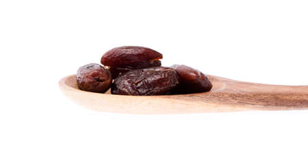 wood ladle of Dried halawi date isolated on a white background.