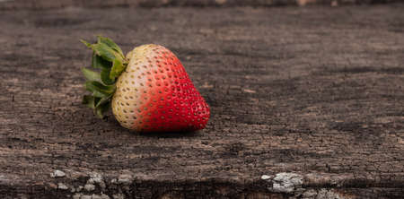 fresh strawberry isolated on wood backgroundの写真素材