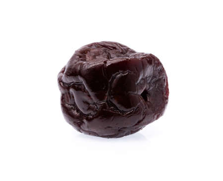 dried plums prunes fruits isolated on white backgroundの写真素材