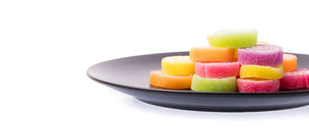 Jelly sweet on a black dish isolated on white background