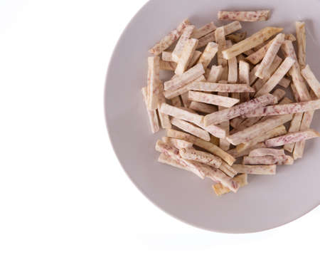 taro snacks on dish isolated on white background.の写真素材