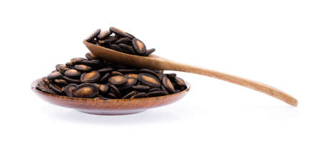 Watermelon seeds on dish isolated on white backgroundの写真素材