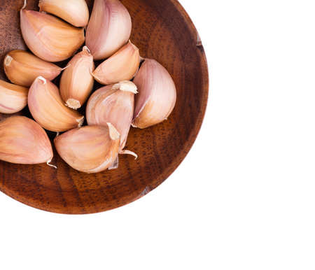 Garlic on dish isolated on white background