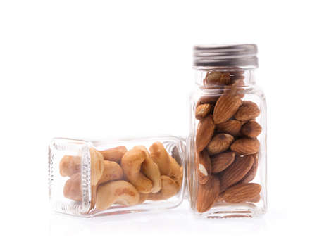 bottle of Cashew nuts with Almonds isolated on white backgroundの写真素材