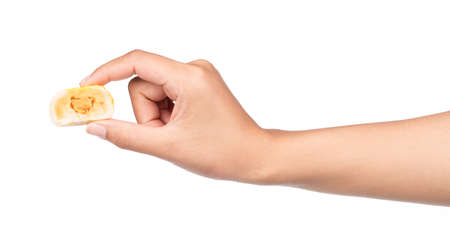 hand holding half of Mochi Sweets isolated on white backgroundの写真素材